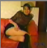 An attractive Asian girl farts while sitting on a sofa.